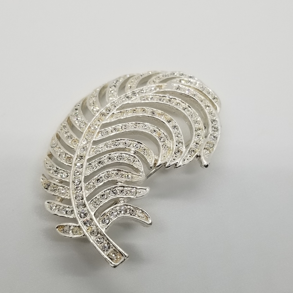 Roman silver tone rhinestone feather brooch